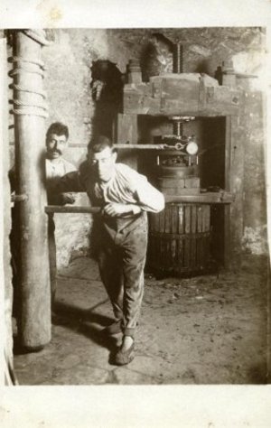 Pagesos fent funcionar la premsa de vi de Can Ponçgem, a la Palma de Cervelló.